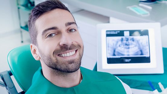 Man getting his dental x-ray for Facial Trauma checked at Utah Valley Oral and Maxillofacial Surgery